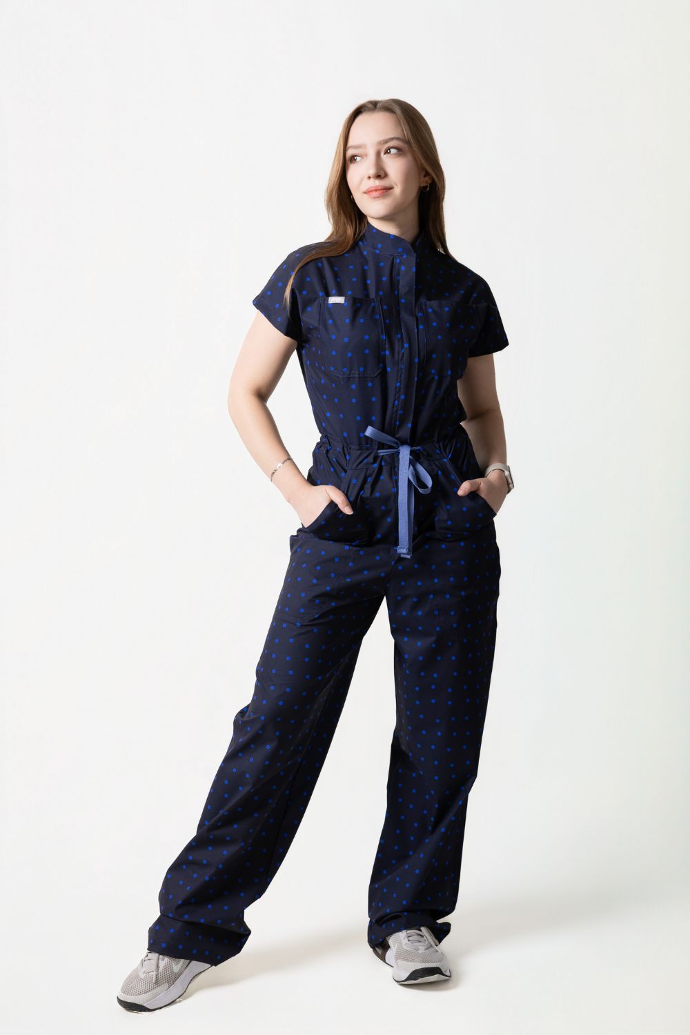 Rebel Jumpsuit Cherry de Jogs Scrubs — enterizo médico antifluidos color vino con polka dots rosa pastel, vista frontal completa